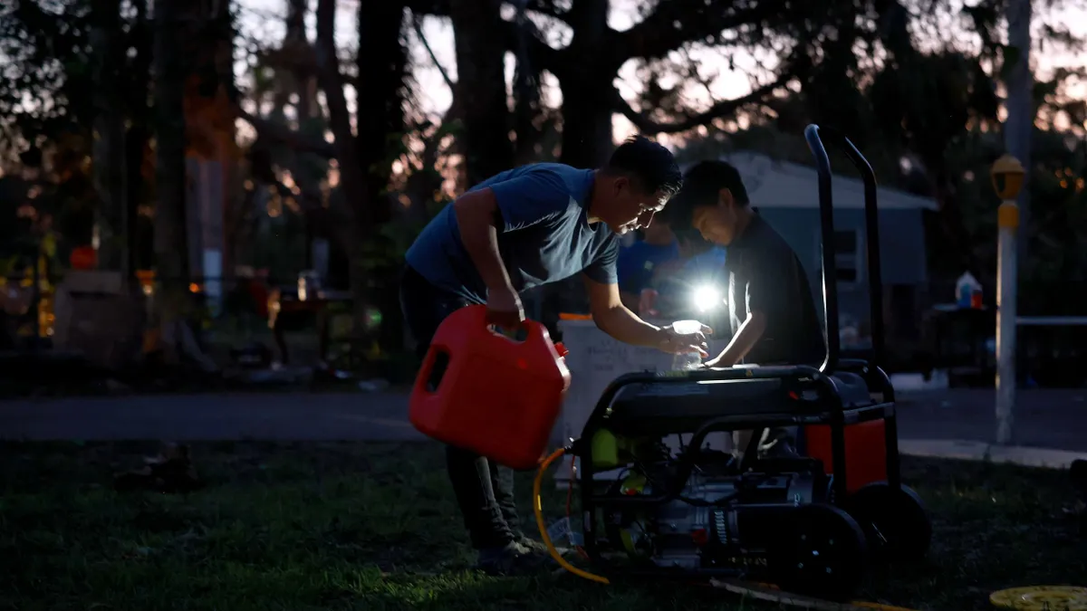 A man fills a generator with gas
