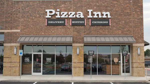 An image of a brick restaurant with white signage that says "Pizza Inn"