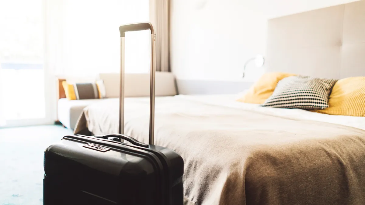 Suitcase sitting in hotel room