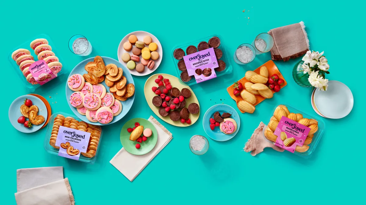 Overhead shot of boxes and plates with cookies.