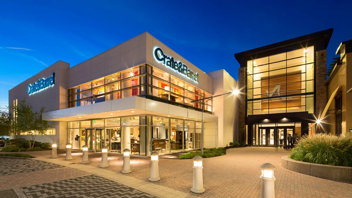 Exterior of a Crate and Barrel store at night.