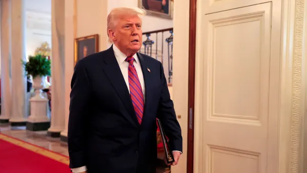 President Donald Trump walks down a hallway toward the East Room of the White House on July 18, 2025 in Washington, D.C.