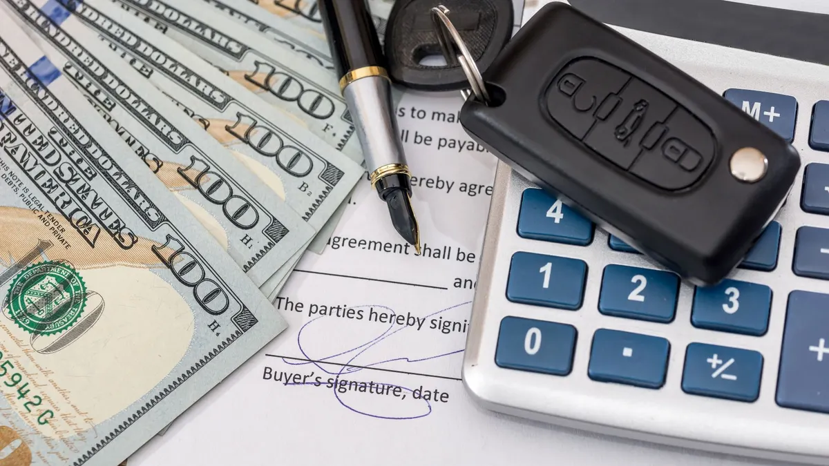 Documant, dollar, pen, calculator and toy car with keys