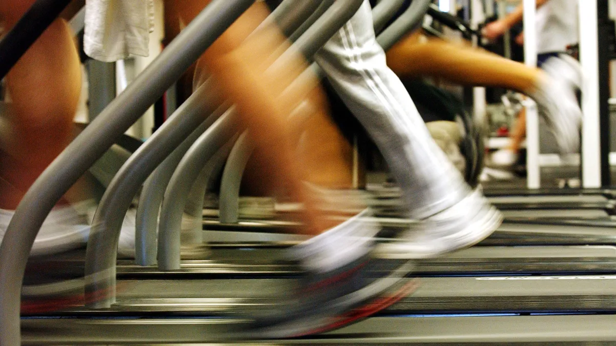 Faceless image of people running on treadmills