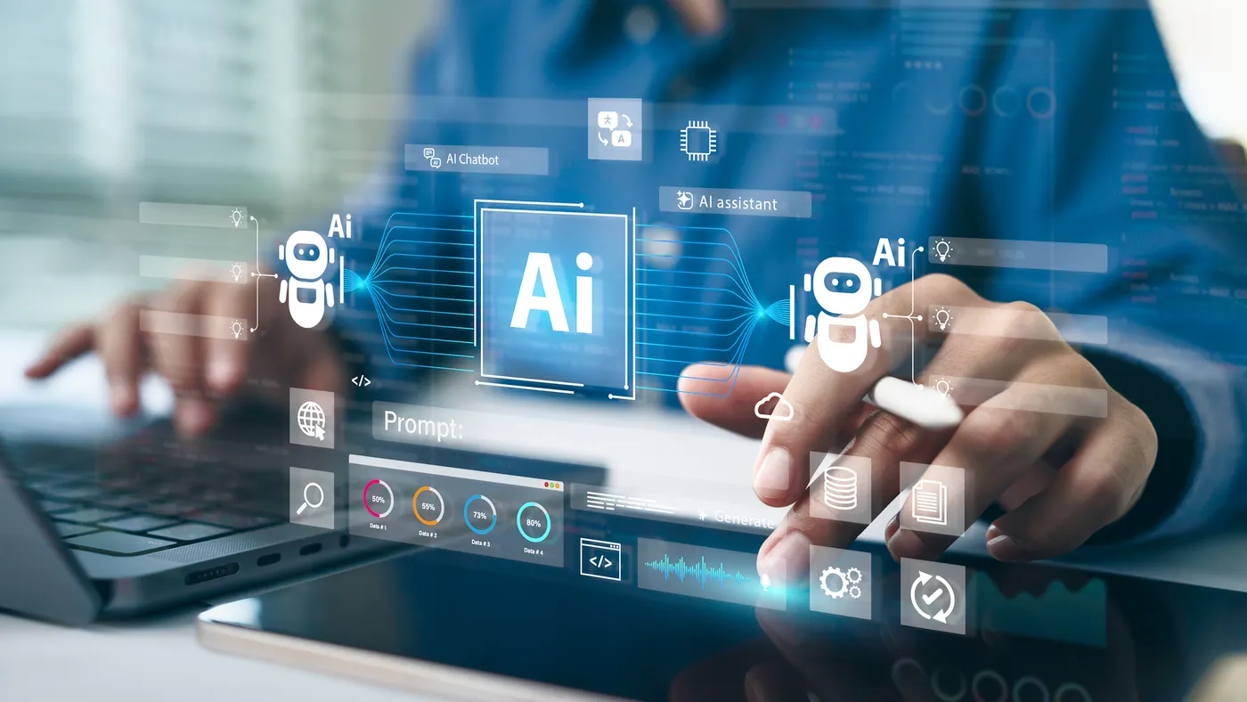 an AI logo superimposed over an image of a man typing on a laptop