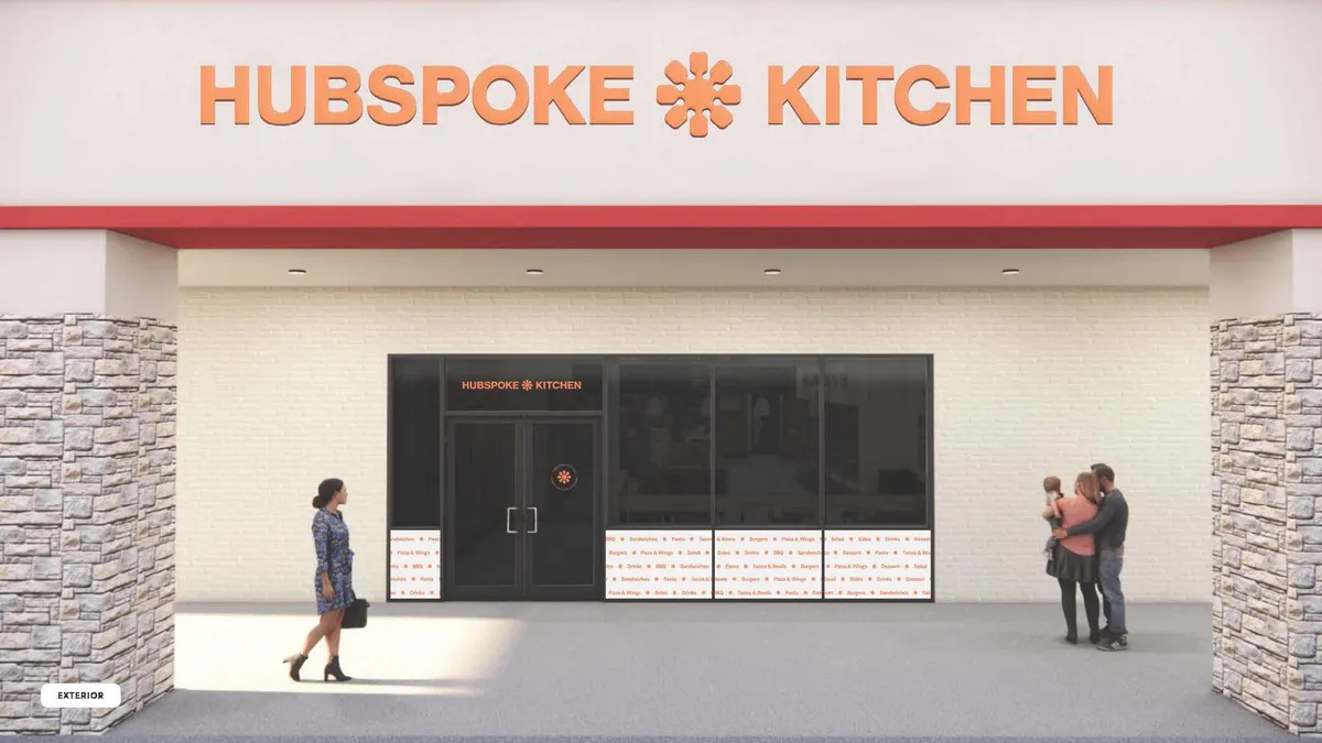 An image of a beige storefront with an orange logo that says "Hubspoke Kitchen"