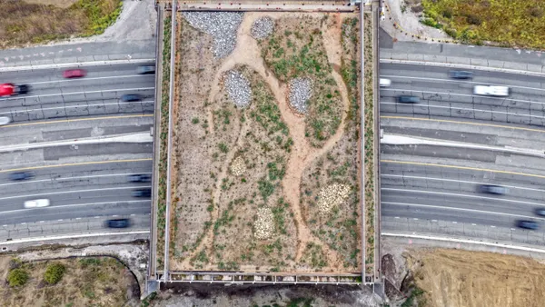 An aerial view of a construction project over a highway.