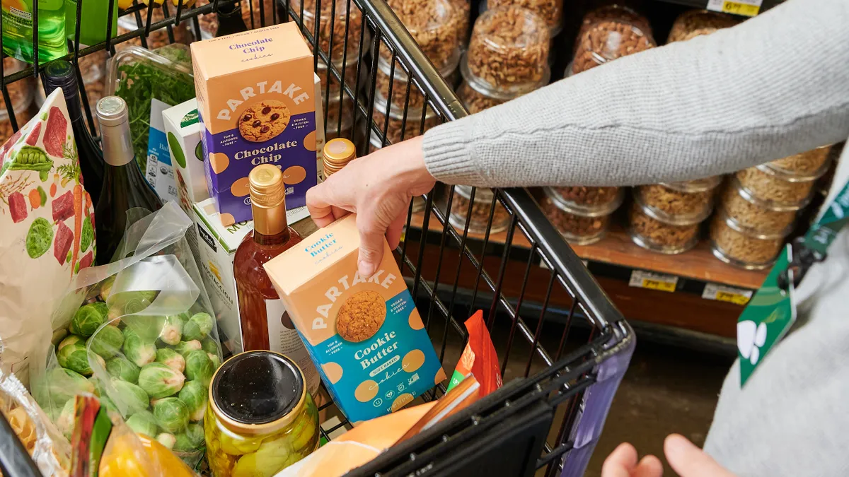 Instacart shopper putting Partake cookies in cart