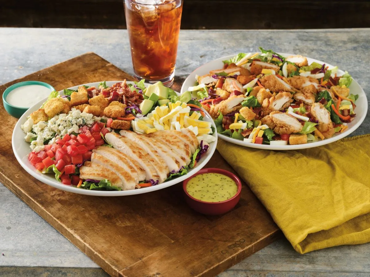 An image of two plates of salad from Red Robin.