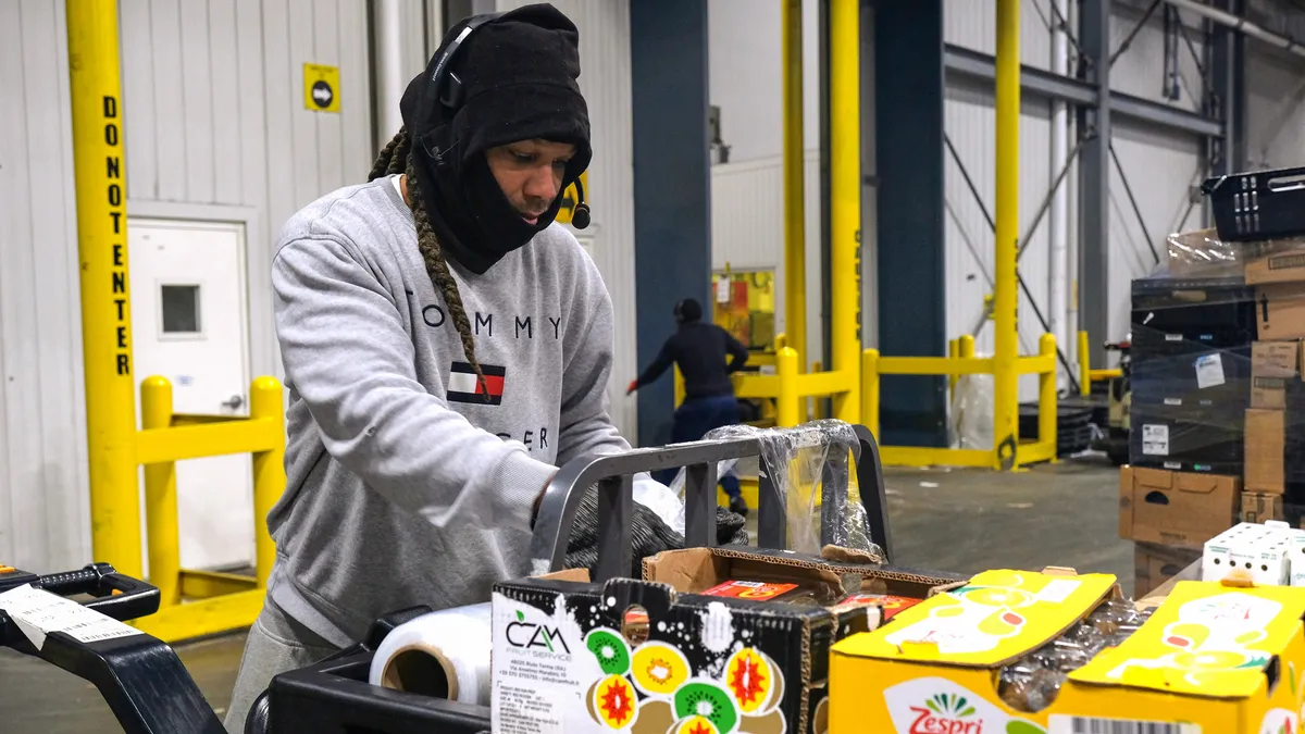 Person on pallet jack in warehouse