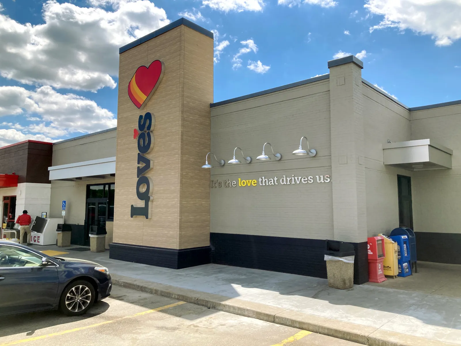 An exterior of a convenience store. A sign says "Love's" and another says "It's the love that drives us."