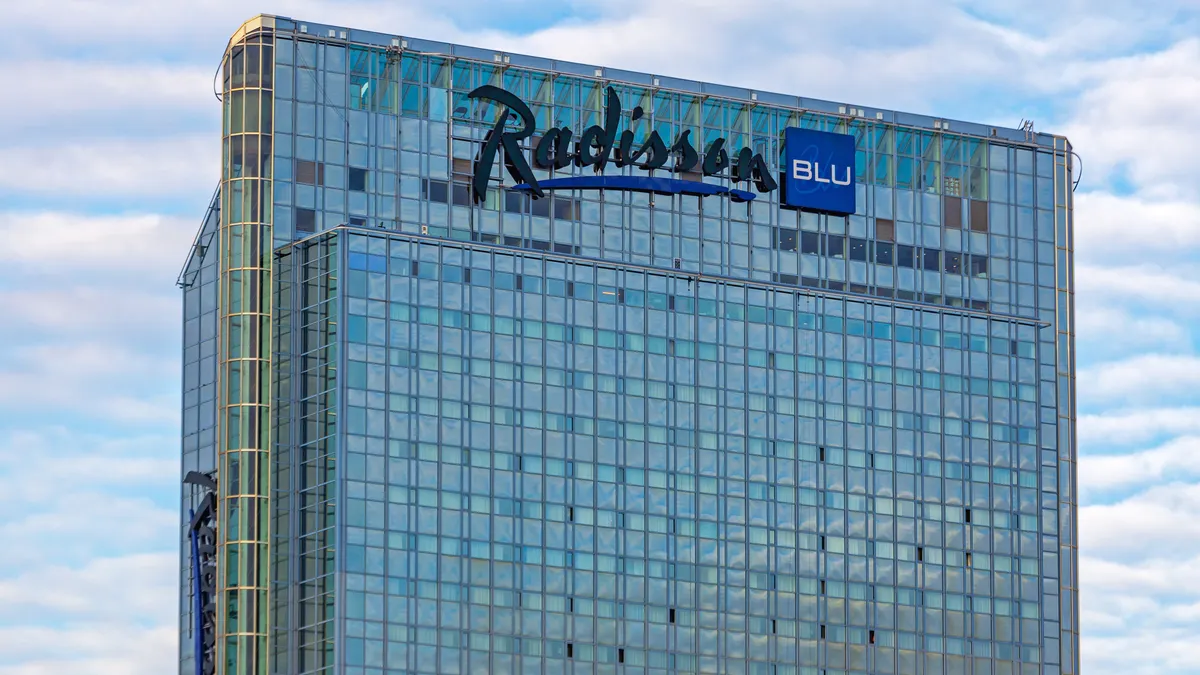 A close up of a Radisson Blu Hotel glass skyscraper in Oslo, Norway