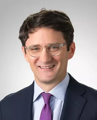 Headshot of a man in a suit.