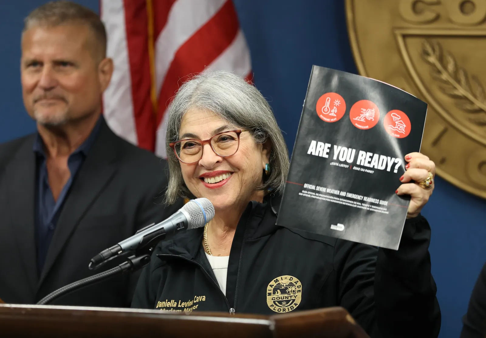 A person holds up a pamphlet.