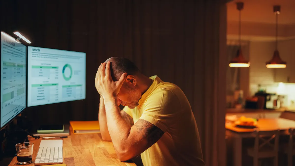 Stressed businessman working late at home