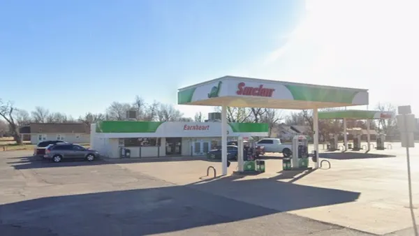 A screenshot showing a gas station and convenience store. The canopy and building are both green and white, with a red sign on the canopy saying Sinclair and a red sign on the building saying Earnheart.