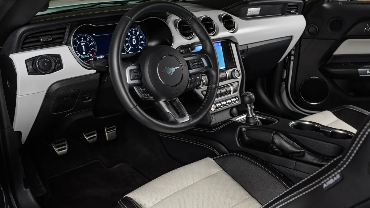 The black and white interior of the 2022 Ford Mustang equipped with the optional Ice White Appearance Package.