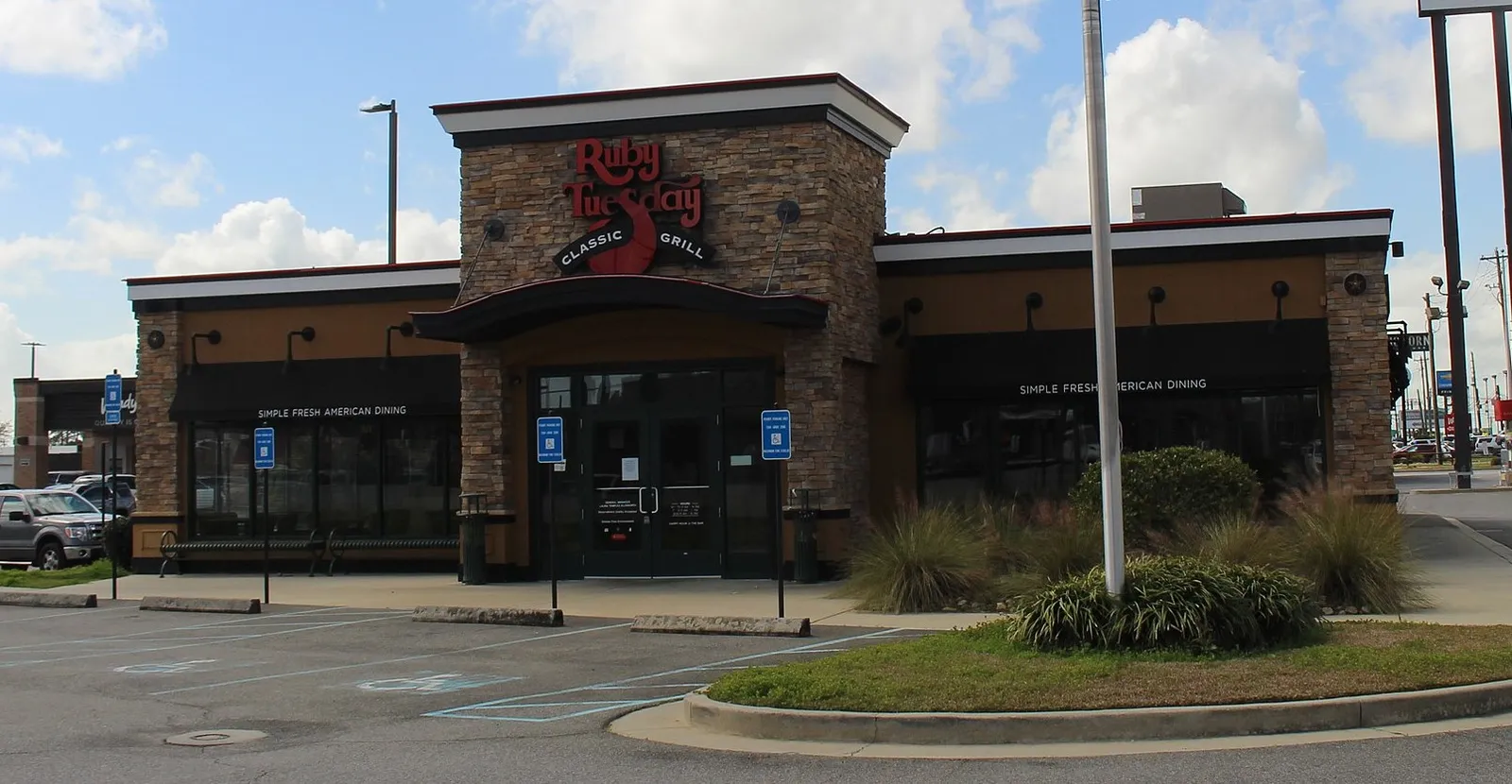 An image of a beige brick building with red lettes that say &quot;Ruby Tuesday.&quot;