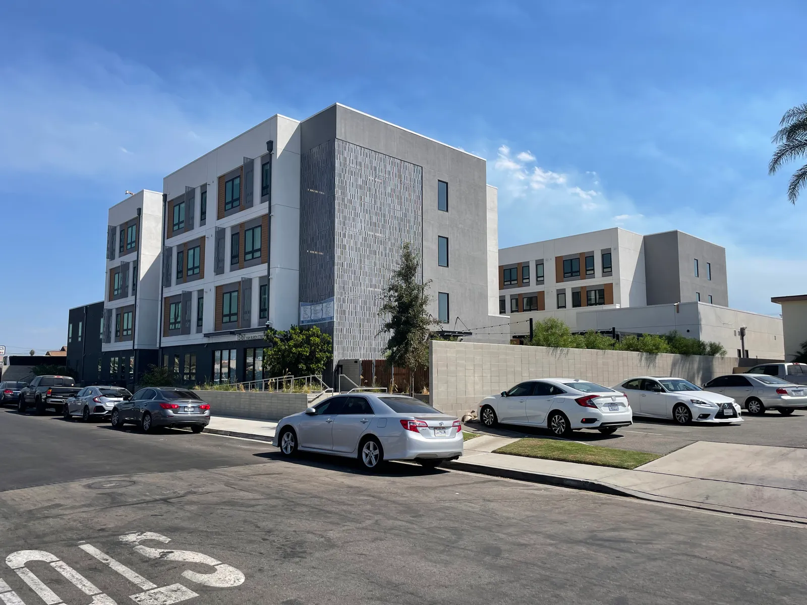 A modern, white apartment building.