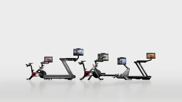 Four home workout machines with screens