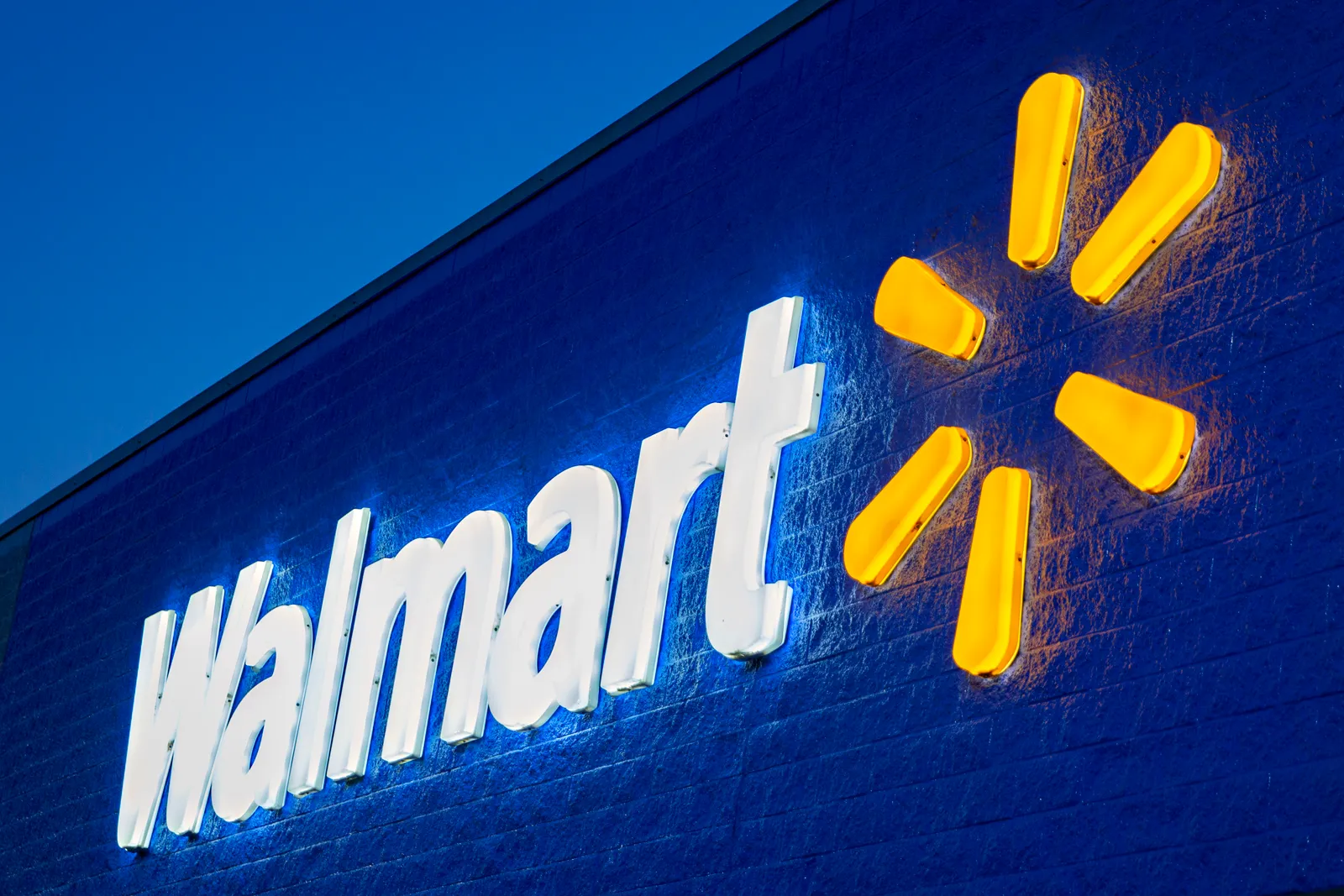 The exterior of a Walmart store at night