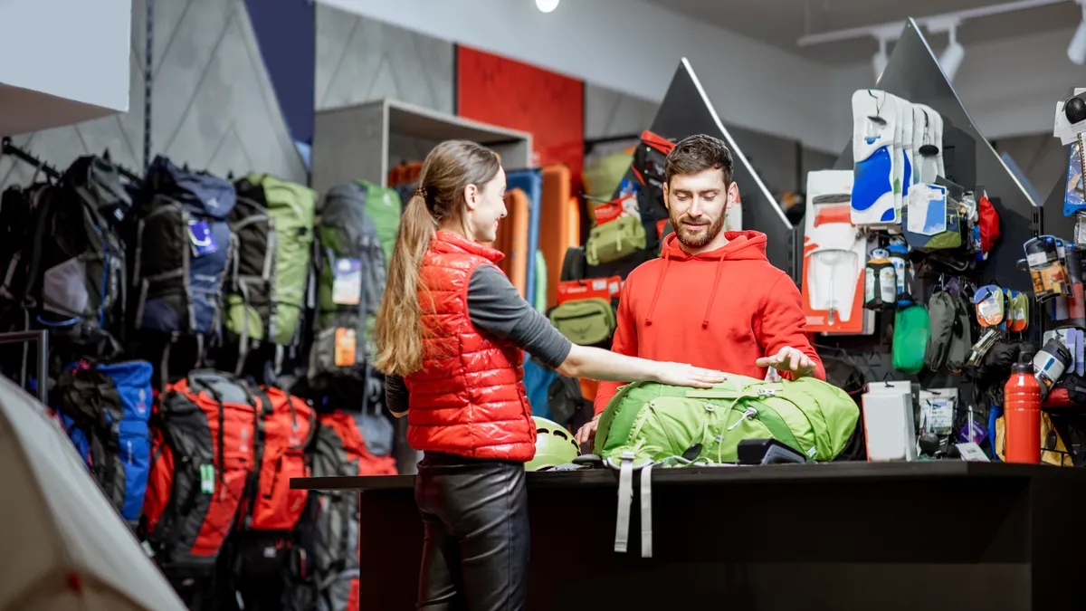 A woman returns an item to an sporting goods store