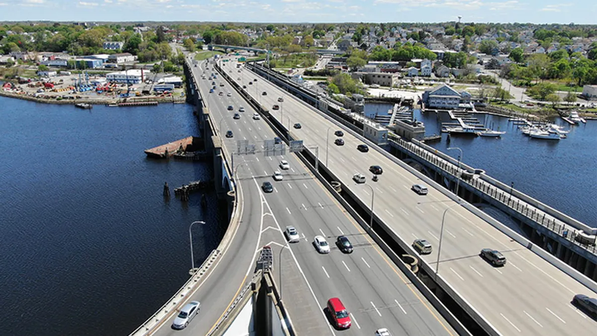 Aerial view of a multi-lane, open pair of bridges with vehicles traveling both directions.