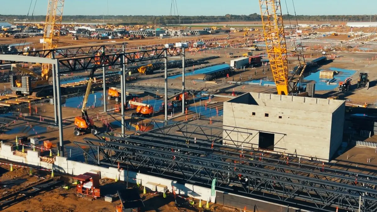 A construction site with heavy machinery in the dawn sunlight.