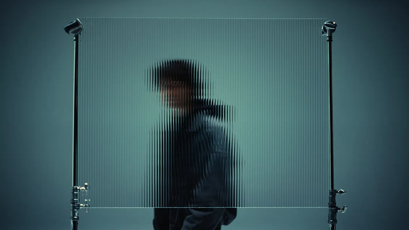 man behind blurry glass