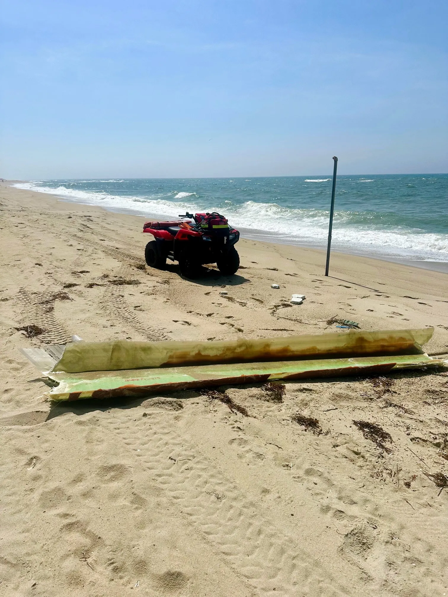 Debris from the broken Vineyard Wind turbine blade lies on a beach in Nantucket.