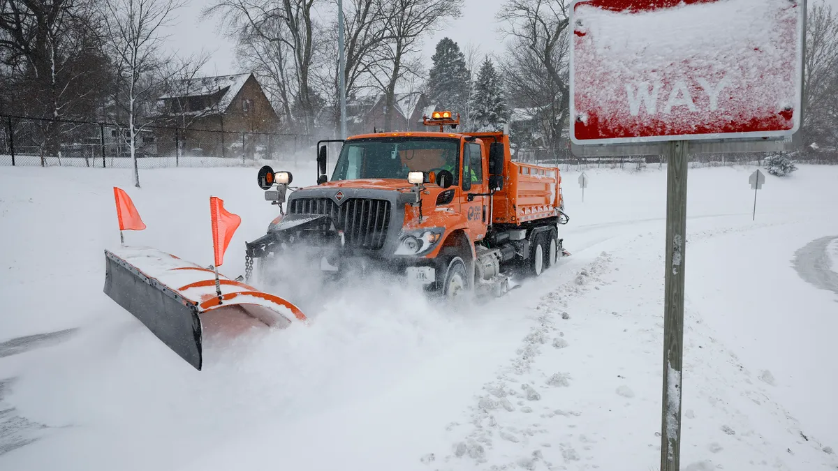 Plow trucks work to clear the Interstate 235 John MacVicar Freeway Freeway as winter storm Gerri dumps inches of snow with high winds in Des Moines, Iowa, on Jan. 12.