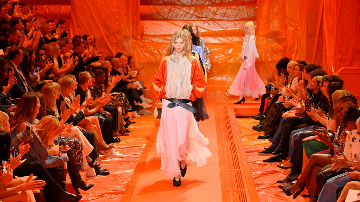 Models walk an orange runway during the Louis Vuitton womenswear show.