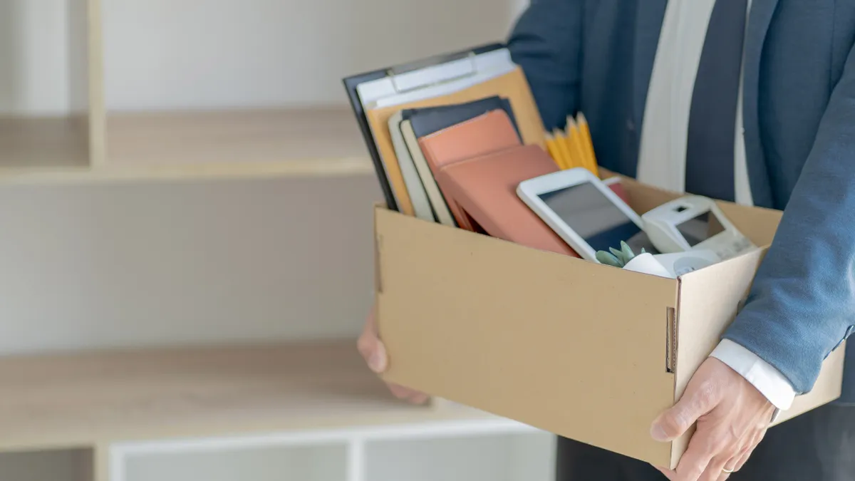 Stressful businessman packing a box