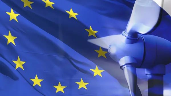Wind turbines in front of national flag of The EU
