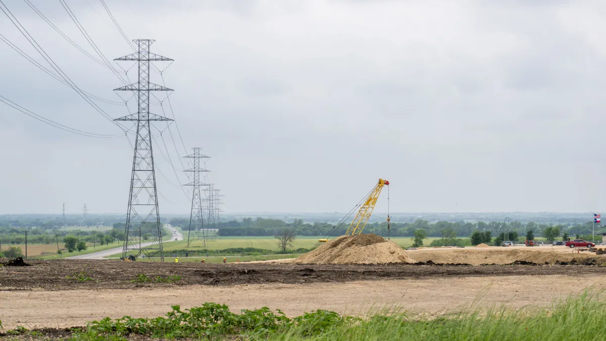 Transmission towers run alongside a road