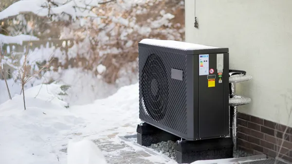 A modern heat pump in a cold, snowy setting