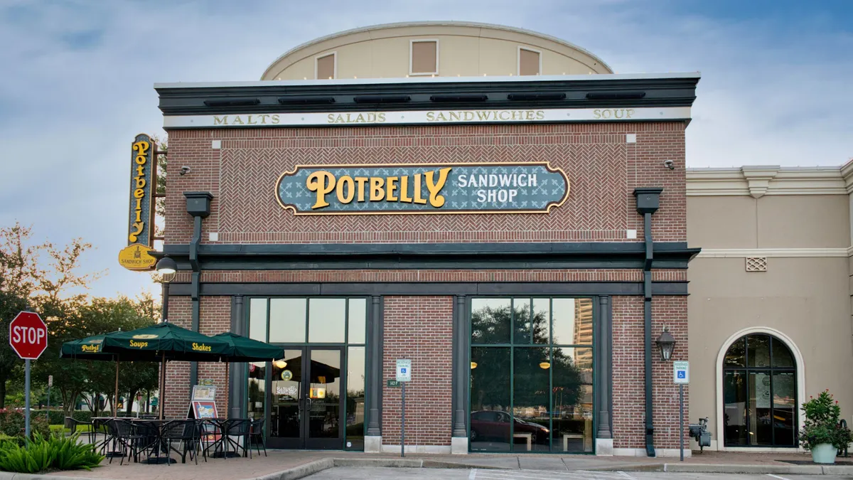 An image of a building with a brick facade and a green sign that says Potbelly