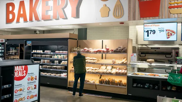 A person shops in the bakery section at an Amazon Fresh grocery store