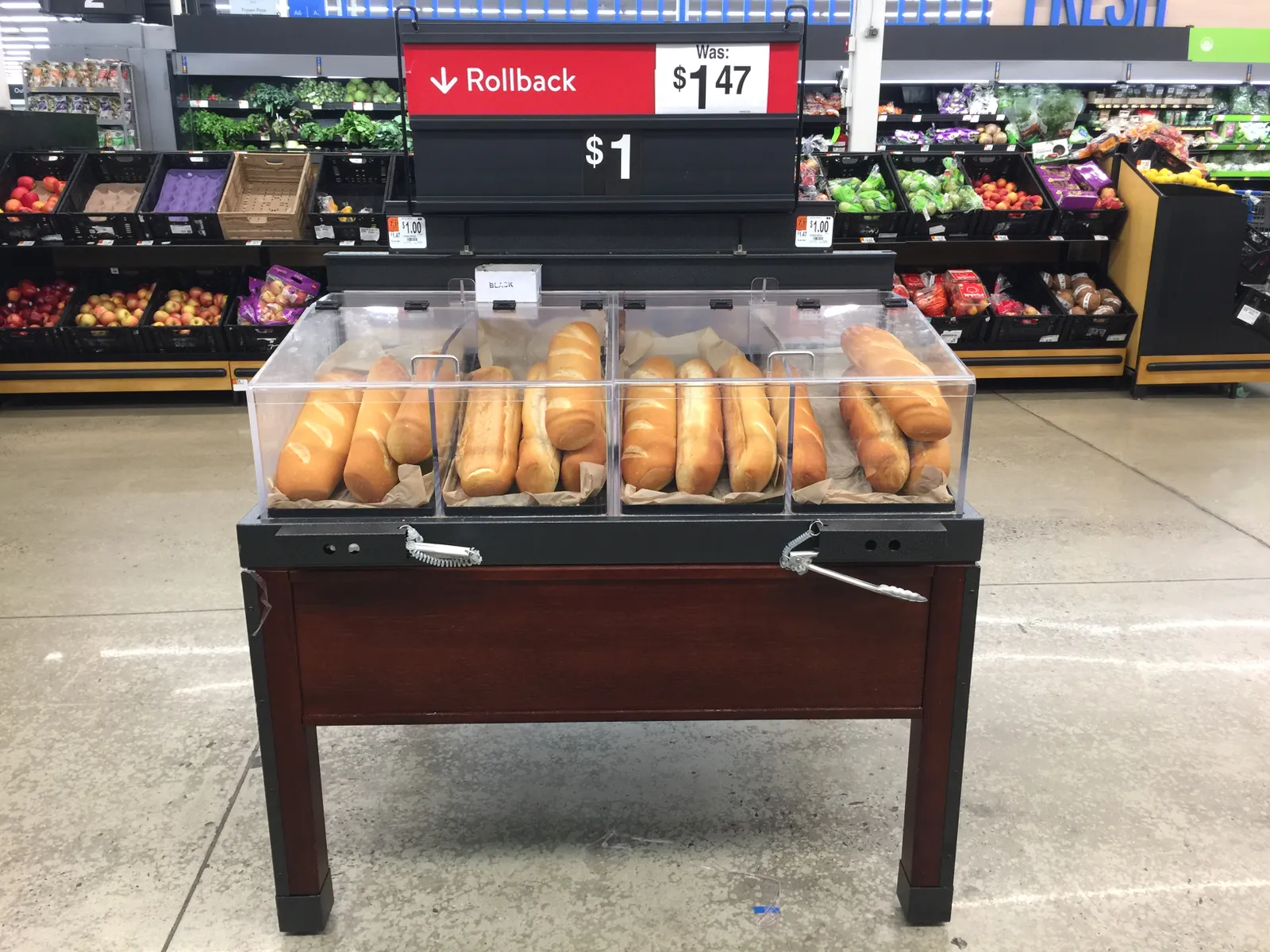 A rollback sign for bread at a store.