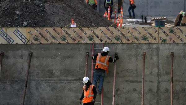 Construction workers build out a new structure