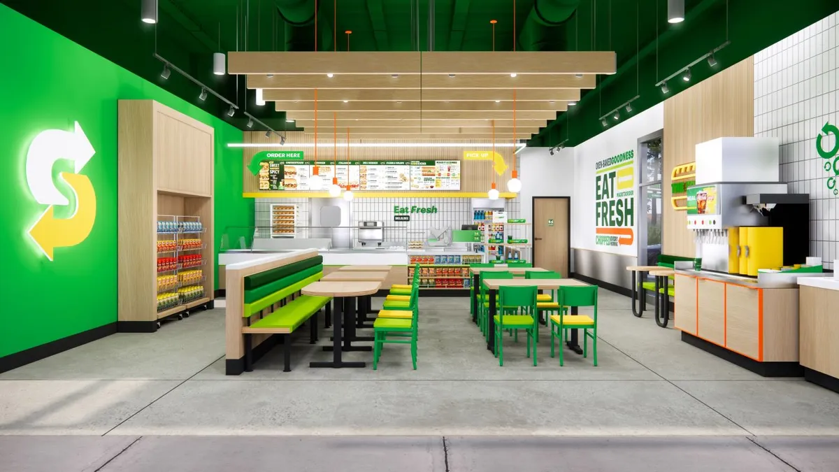 A rendering of a Subway restaurant with tables and green walls.