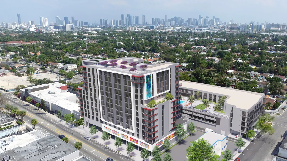 aerial shot of light-colored, high0rise apartment building