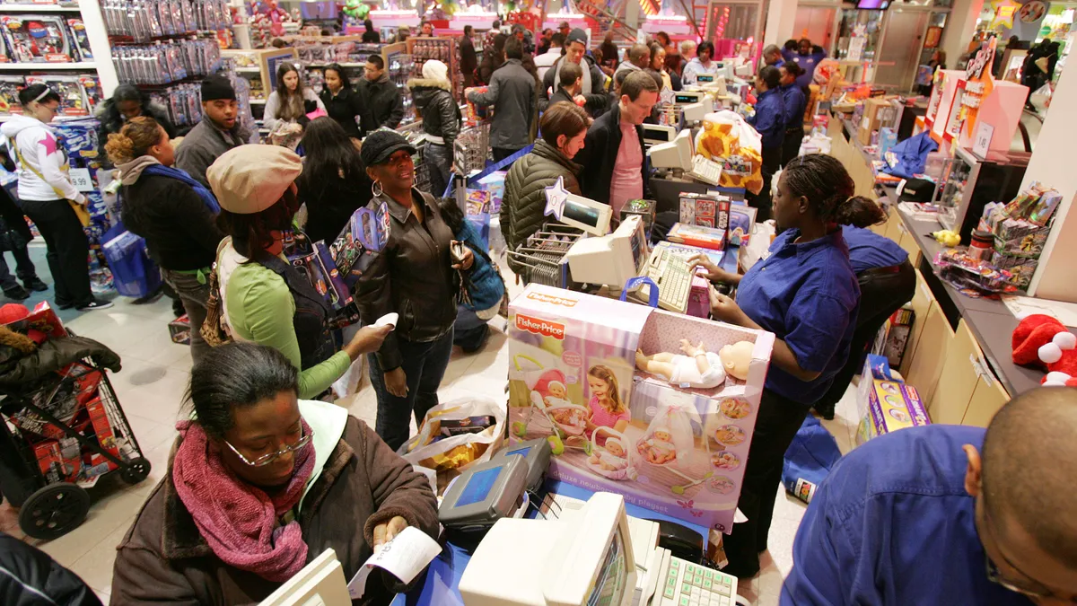 Shoppers at a busy checkout stand in-store.