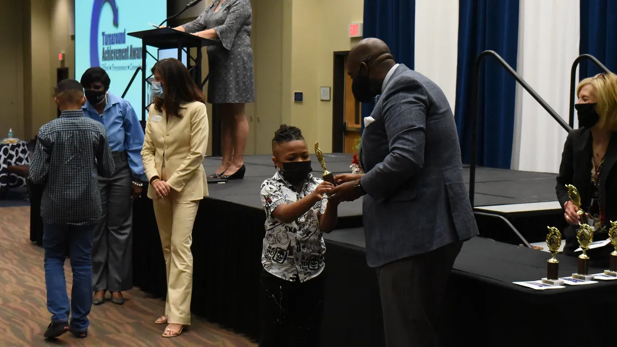 Richland School District Two Superintendent Baron Davis interacts with a student at the district's 2021 Turnaround Achievement Awards.