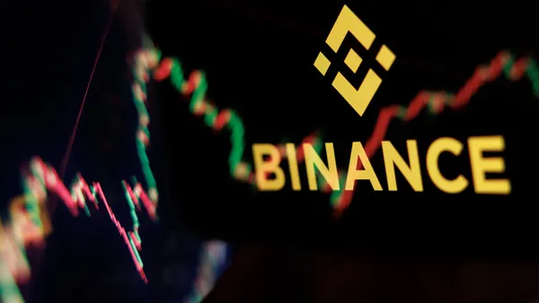 The word "Binance" and a diamond-shaped logo are superimposed on a multi-colored jagged line.