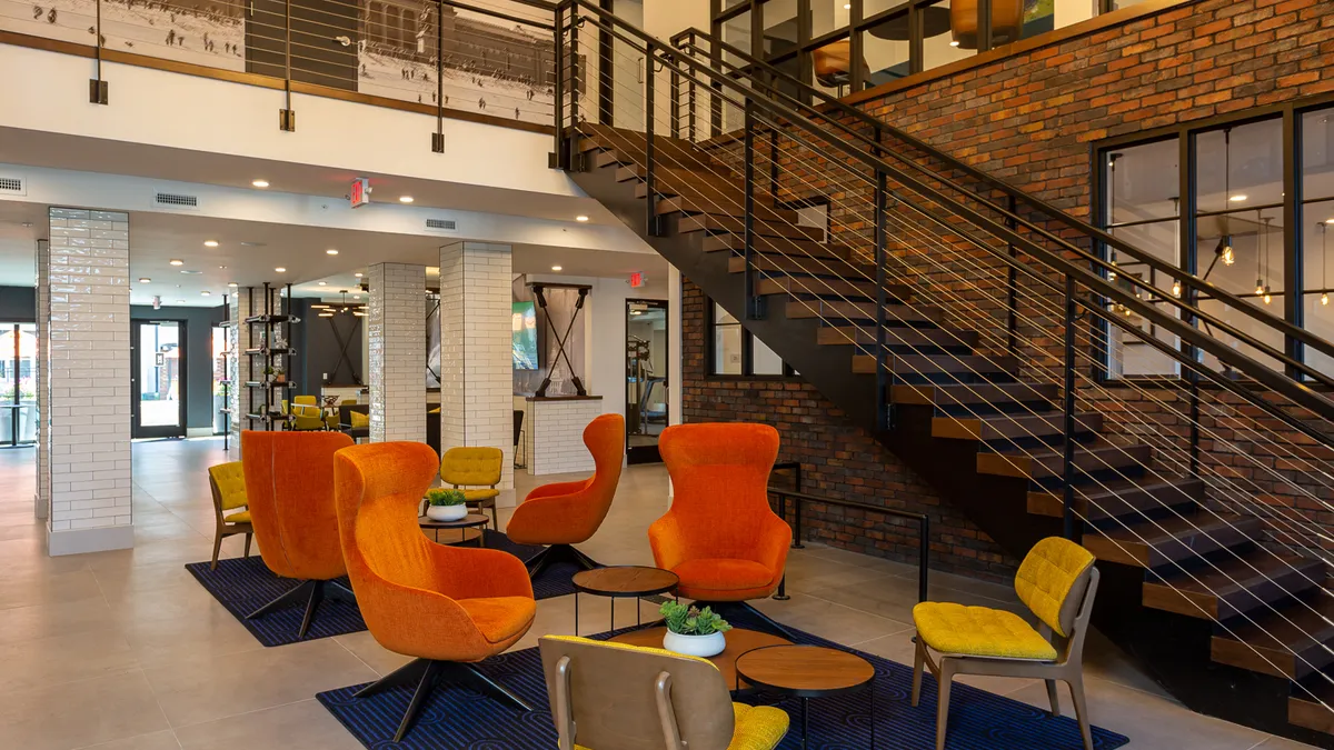 A lobby with tables and chairs.