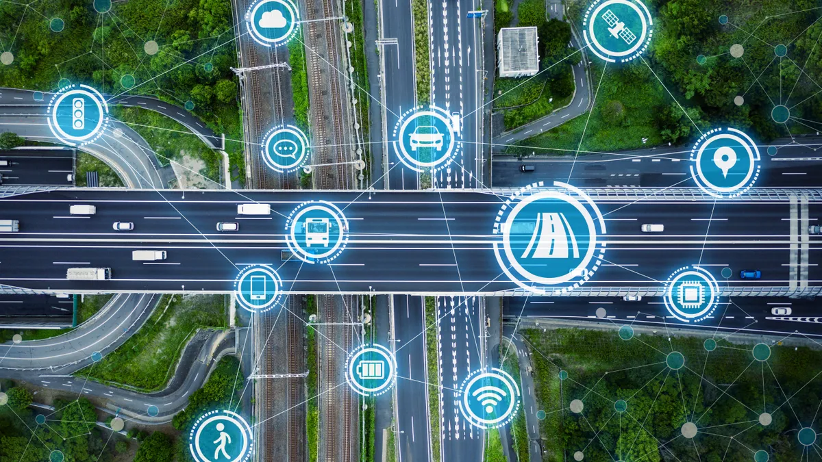 Aerial shot of vehicles on intersecting roads, with circle icons connected by lines in the foreground