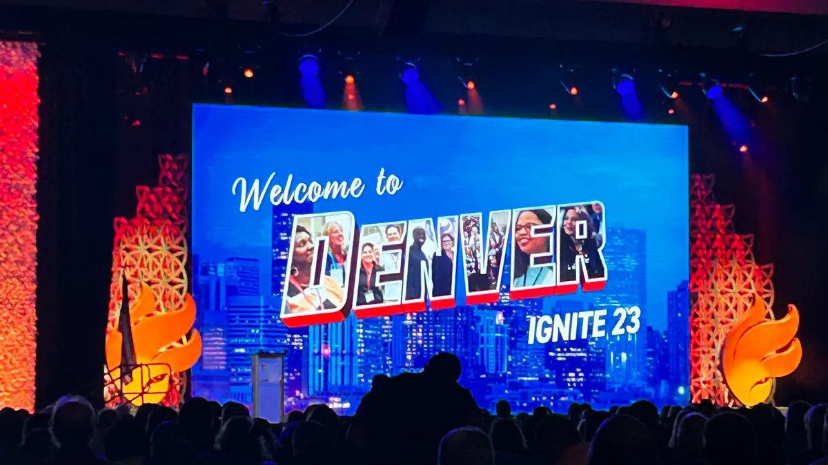 A welcome sign appears in front of a large crowd for the National Association for Secondary School Principals' Ignite '23 conference in Denver, Colo.