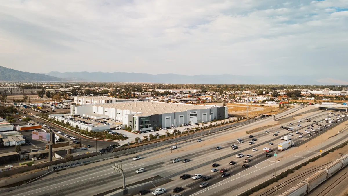 An EV company's new assembly plant next to a highly trafficked highway.