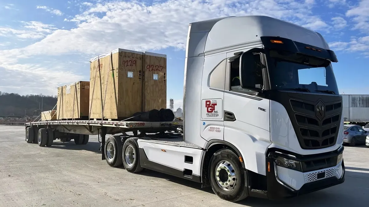 A Nikola Tre battery-electric vehicle with a PGT Trucking logo on it.